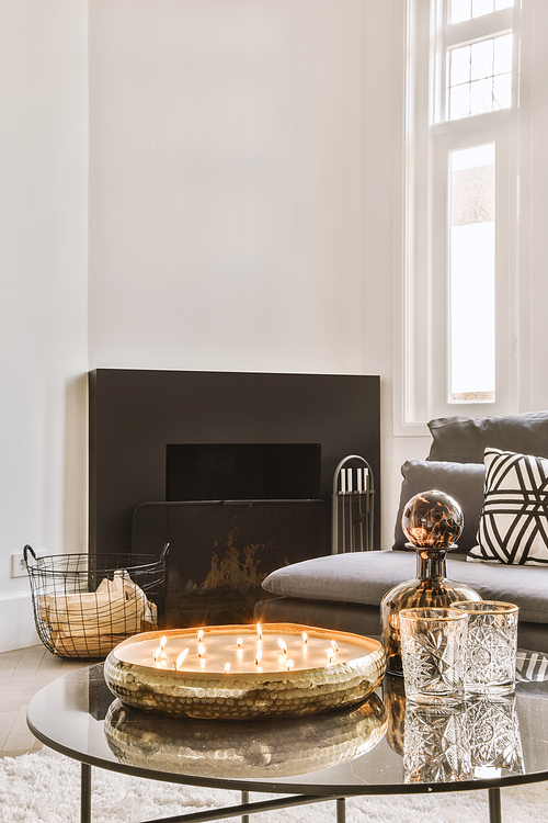 Spacious, bright living room with a fireplace next to the sofa in a ozy house