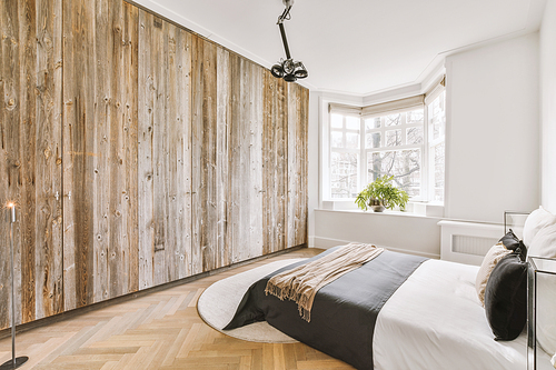 The interior of a bedroom with a large bed and bright designs in a modern house