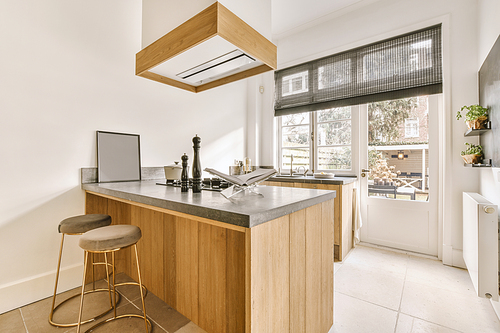 The interior of a spacious, bright kitchen with wooden furniture in a modern house