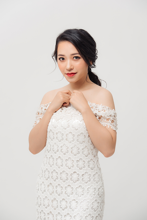 Happy portrait of elegant young Asian woman with white dress. Beauty, fashion concept.