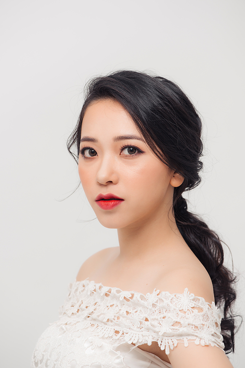 Portrait of beautiful elegant young Asian woman on white background.