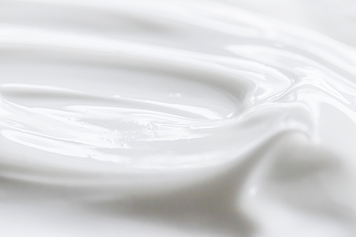 Pure white cream texture as abstract background, food substance or organic cosmetics