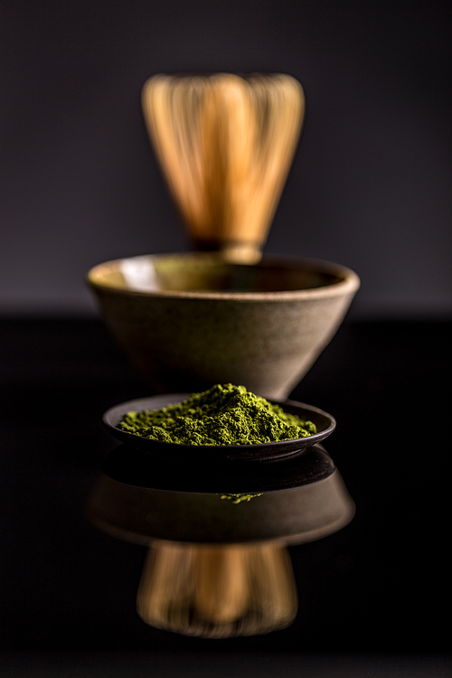 Organic green matcha tea on black background
