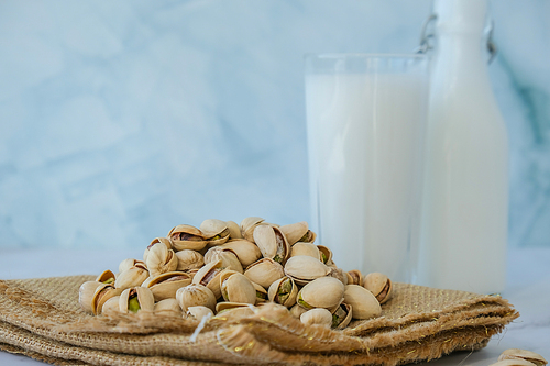 Pistachio lactose free milk for dietary nutrition. Alternative food and vegetarianism. Glass of healthy pistachio milk stands on concrete background. Diet milk, vegetarian food. Gluten free. Nut non-dairy milk