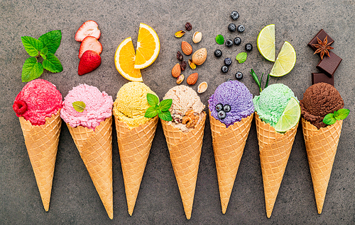 Flat lay ice cream cones collection on dark stone background . Blank crispy ice cream cone with copy space for sweets menu design.