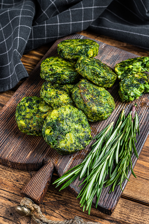 Roasted vegetarian broccoli and pea vegetable patty or cutlet, falafel. wooden background. Top view.