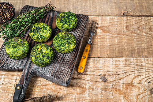 Vegetarian vegetable burgers patty with herbs on wooden board. Wooden background. Top view. Copy space.