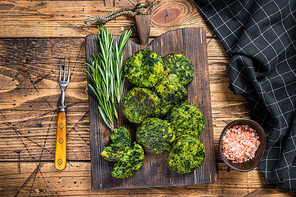 Roasted vegetarian broccoli and pea vegetable patty or cutlet, falafel. wooden background. Top view.