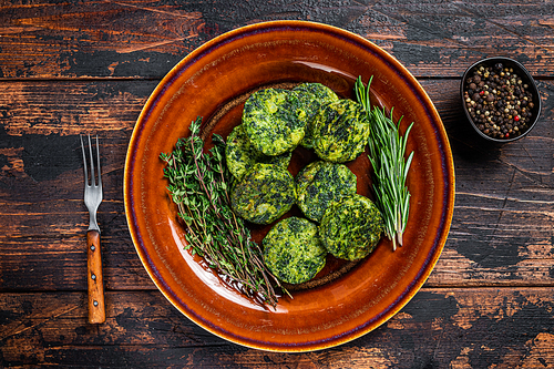 Fried vegetarian broccoli vegetable burgers patty on a rustic plate. Dark wooden background. Top view.