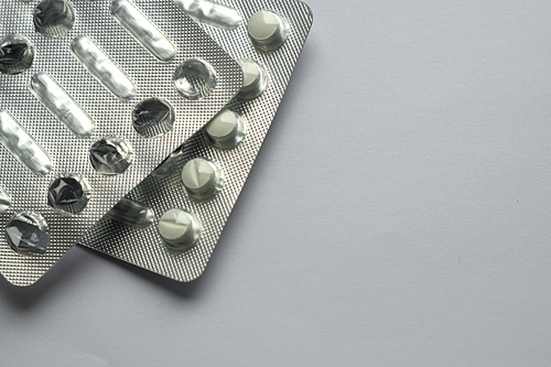 Tablets for colds on a gray background with copy space. Medicines. Means of treatment of diseases