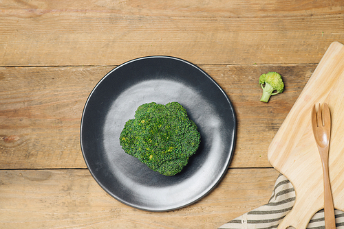 Fresh broccoli in dish on a wooden background