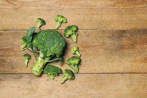 Top view of Fresh green broccoli on rustic wooden background - healthy or vegetarian food.