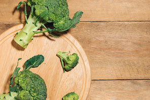 Top view of Fresh green broccoli on rustic wooden background - healthy or vegetarian food.