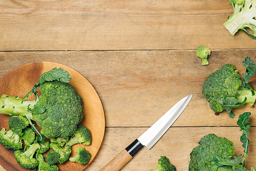 Top view of Fresh green broccoli on rustic wooden background - healthy or vegetarian food.