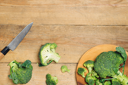 Top view of Fresh green broccoli on rustic wooden background - healthy or vegetarian food.