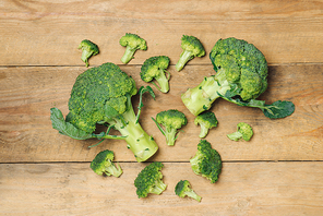 Top view of Fresh green broccoli on rustic wooden background - healthy or vegetarian food.