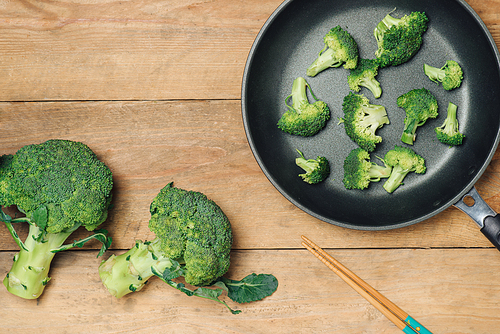 Top view of Fresh green broccoli on rustic wooden background - healthy or vegetarian food.