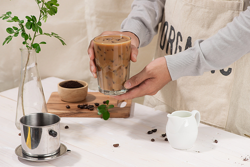 Ice coffee with fresh coffee on a wooden background, Coffee with milk and ice on natural wooden