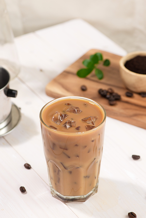 Ice coffee with fresh coffee on a wooden background, Coffee with milk and ice on natural wooden