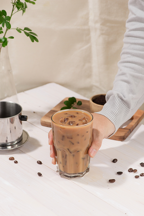 Ice coffee with fresh coffee on a wooden background, Coffee with milk and ice on natural wooden