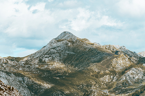 Colorful landscape of the mountains of Asturias during a sunny day, Covadonga lakes, peaceful scenario, snowy mountains, copy space