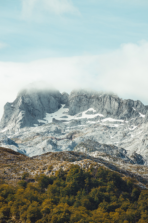 Colorful landscape of the mountains of Asturias during a sunny day, Covadonga lakes, peaceful scenario, snowy mountains, copy space