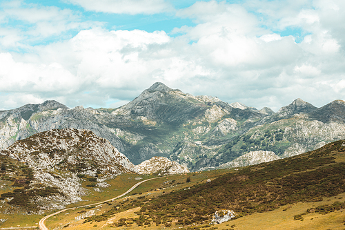 Colorful landscape of the mountains of Asturias during a sunny day, Covadonga lakes, peaceful scenario, snowy mountains, copy space