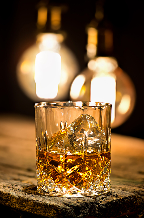 Glass of whiskey lighting with edison lamps