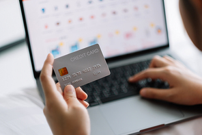woman shopping online with credit card. woman holding credit card and using laptop. Online shopping concept.