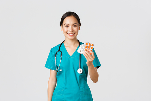 Healthcare workers, preventing virus, quarantine campaign concept. Friendly-looking female asian nurse, doctor explain patient medication prescription, showing drugs and smiling, white background.