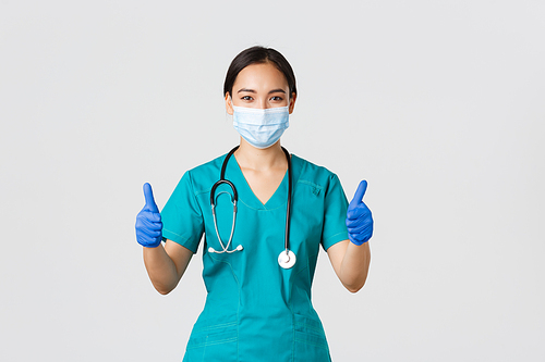 Covid-19, coronavirus disease, healthcare workers concept. Confident professional doctor, asian physician in personal protective equipment, guarantee and ensure patient, stay safe in medical mask.