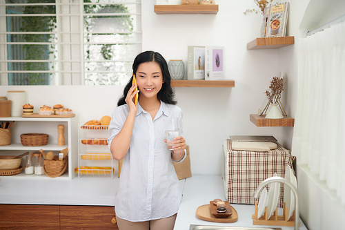 Girl talking on the phone in the kitchen