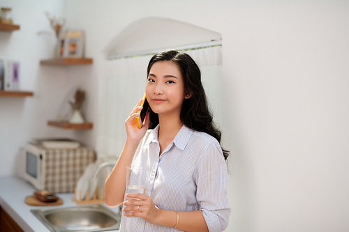 Girl talking on the phone in the kitchen