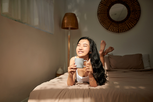 Woman in bed drinking tea. Woman enjoying tea in the bed in the morning.
