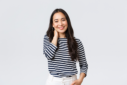 Lifestyle, people emotions and casual concept. Joyful beautiful asian woman in stylish casual clothes, touch neck blushing and smiling, having small talk at romantic date.
