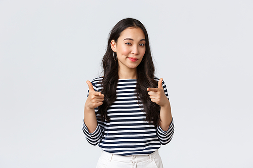 Lifestyle, people emotions and casual concept. Well done, nice played. Pleased and impressed asian girl pointing fingers at camera to praise you, encourage or congratulate with great job.