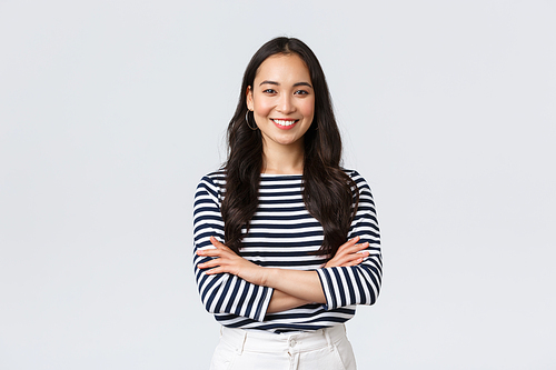 Lifestyle, people emotions and casual concept. Confident nice smiling asian woman cross arms chest confident, ready to help, listening to coworkers, taking part conversation.
