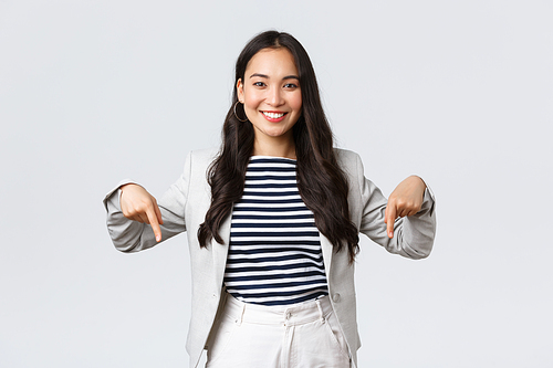 Business, finance and employment, female successful entrepreneurs concept. Confident professional female asian real estate broker showing good deal, pointing fingers down and smiling.