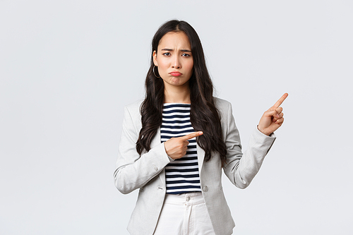 Business, finance and employment, female successful entrepreneurs concept. Upset gloomy young female office manager have failed, feeling uneasy and distressed, sulking as pointing upper right corner.