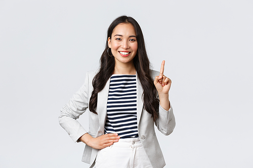 Business, finance and employment, female successful entrepreneurs concept. Good-looking confident female asian real estate broker being number one, offer good deal, showing finger and smiling.