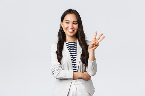 Business, finance and employment, female successful entrepreneurs concept. Successful female businesswoman, asian real estate broker pointing finger, showing number three and smiling.