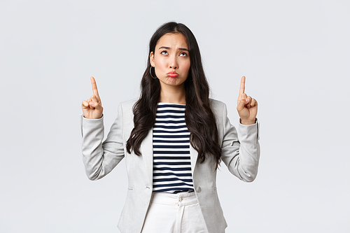 Business, finance and employment, female successful entrepreneurs concept. Gloomy and upset businesswoman feeling uneasy of missed opportunity, pointing up and sulking sad.