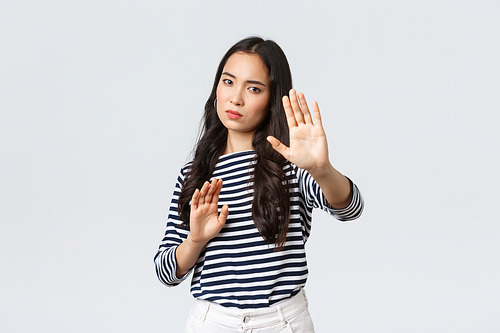 Lifestyle, beauty and fashion, people emotions concept. Annoyed woman feeling uncomfortable being photographed, asking turn-off camera, raising hands up defensive, protecting face from flashlight.