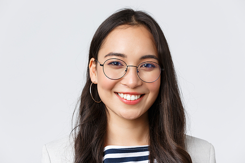 Business, finance and employment, female successful entrepreneurs concept. Good-looking asian businesswoman in glasses and suit smiling friendly and confident, working in office.