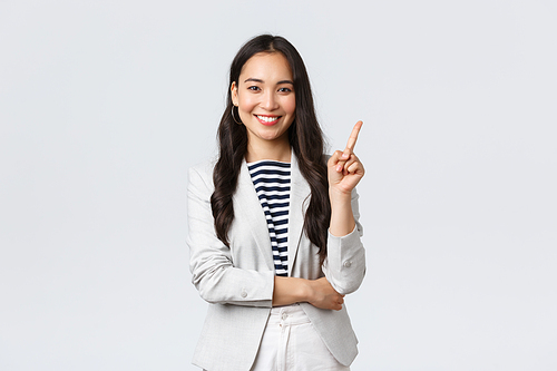 Business, finance and employment, female successful entrepreneurs concept. Successful female businesswoman, asian real estate broker pointing finger, showing number one and smiling.