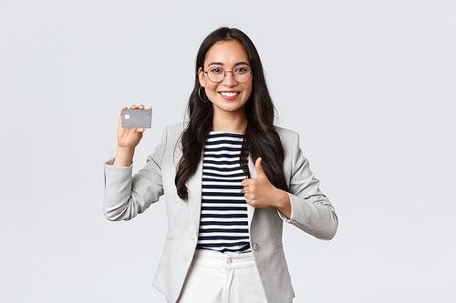 Business, finance and employment, entrepreneur and money concept. Professional female bank clerk, office manager recommend credit card, banking service, showing thumbs-up.