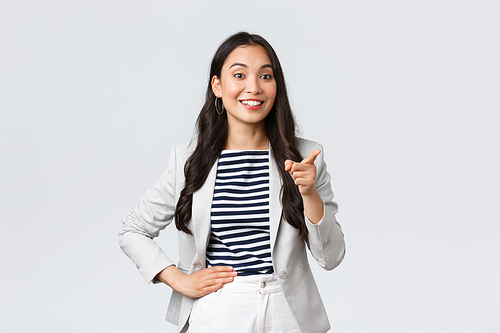 Business, finance and employment, female entrepreneurs concept. Smiling successful asian businesswoman giving speech on meeting, praise nice idea of employee, pointing finger say good point.