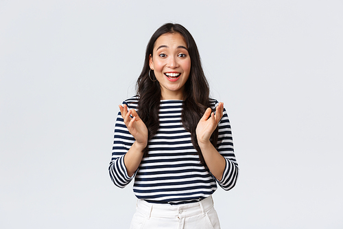 Lifestyle, people emotions and casual concept. Rejoicing happy asian girl clap hands surprised and excited, receive good news, congratulating friend, standing white background.