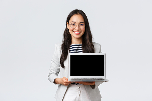 Business, finance and employment, female successful entrepreneurs concept. Talented real estate broker showing location to clients on laptop screen, having meeting with coworkers at office.