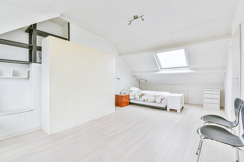 Single soft bed in the bedroom with parquet floor